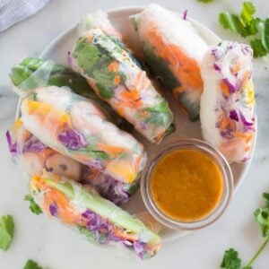 Fresh spring rolls on a plate with peanut dipping sauce,