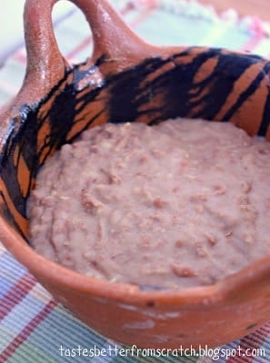 A brown dish filled with semi-homemade refried beans.