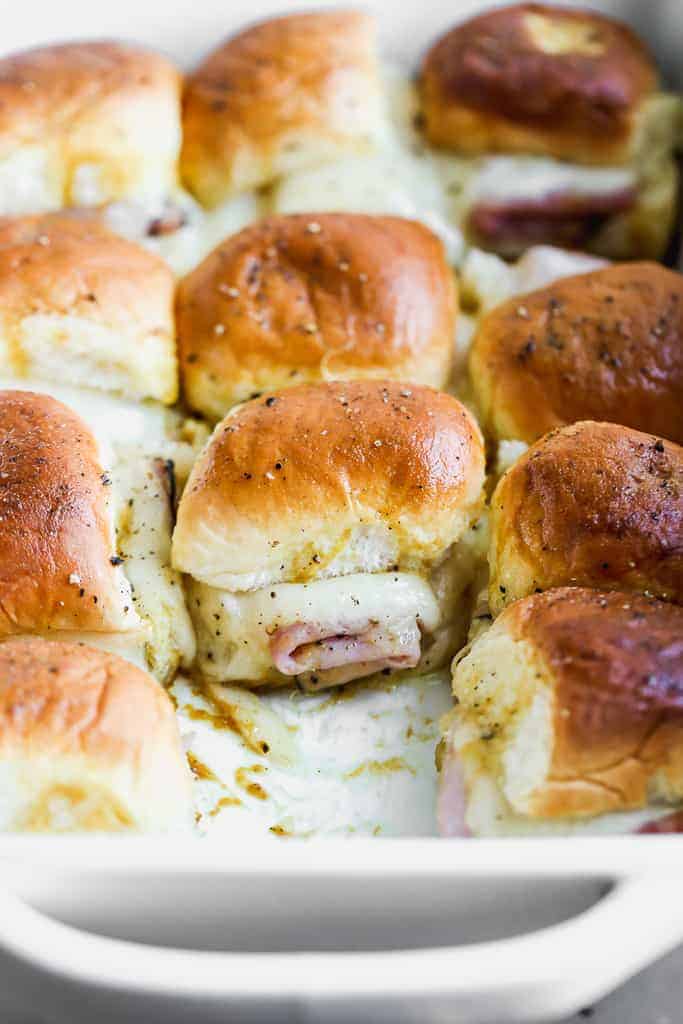 Close up of baked ham and cheese sliders.