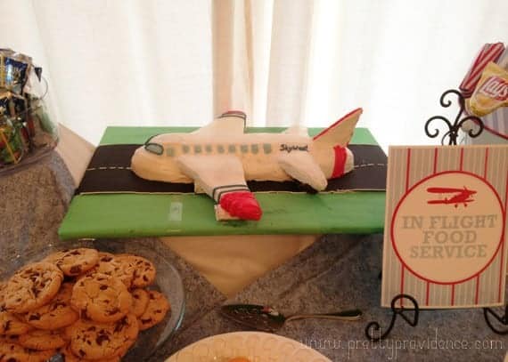 Finished airplane cake presented on party table.
