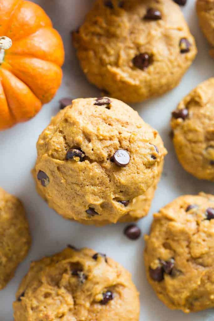 Pumpkin Chocolate Chip Cookies on parchment paper.