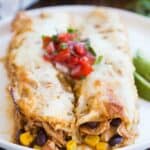 These honey lime chicken enchiladas are one of our favorites! The filling includes marinated Honey lime chicken, black beans, corn, and cheese, rolled in tortillas and smothered in salsa verde. | tastesbetterfromscratch.com