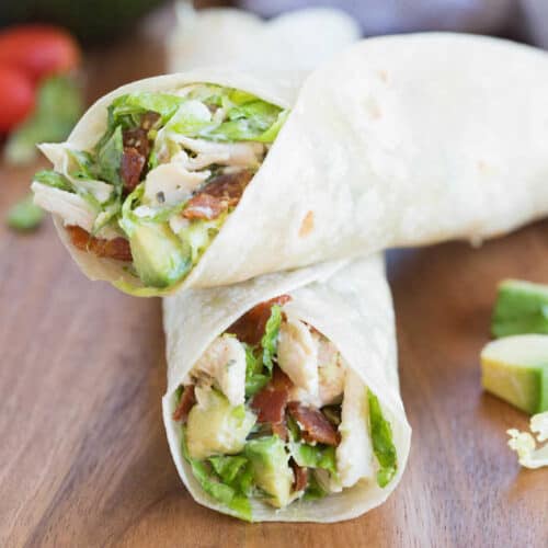 Chicken Bacon Avocado Wrap is one of my favorite easy dinner ideas! Lettuce, chicken, bacon and avocados tossed in a yummy dressing and layered inside a warm tortilla. | Tastesbetterfromscratch.com
