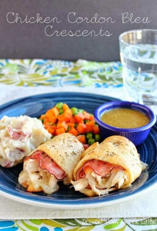 Chicken cordon bleu crescents on a plate with mashed potatoes and vegetables.