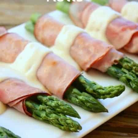 Ham asparagus rolls laid ona platter.