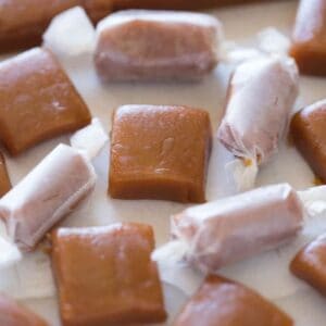 Homemade caramel candies some wrapped and some unwrapped. |
