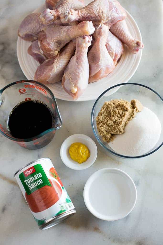 The ingredients for bbq chicken, including chicken legs, soy sauce, tomato sauce, mustard, sugar and vinegar.