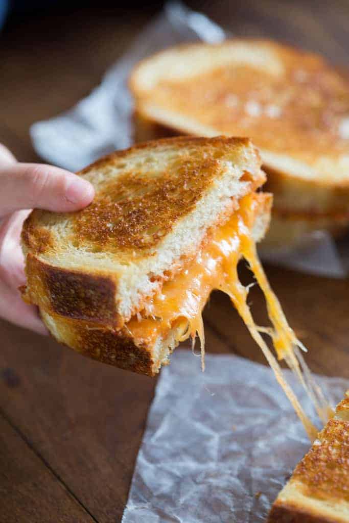 Half of an Italian Grilled Cheese Sandwich being pulled away from the other half.
