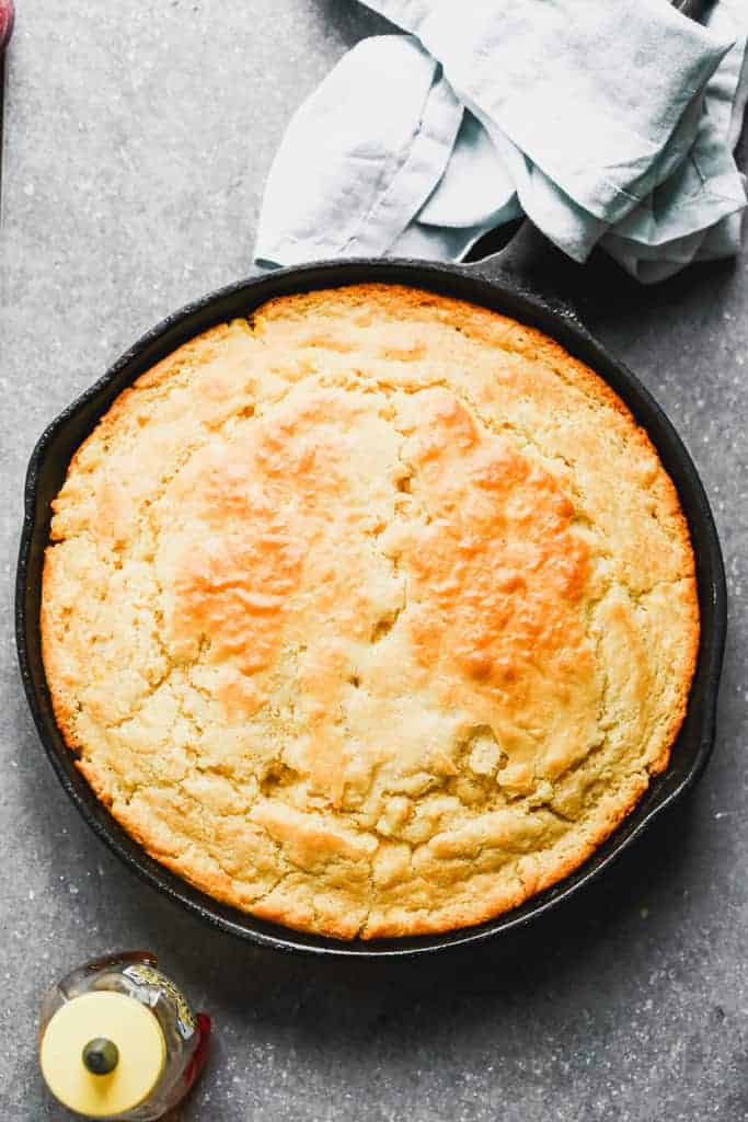 A cast iron skillet with baked cornbread in it.