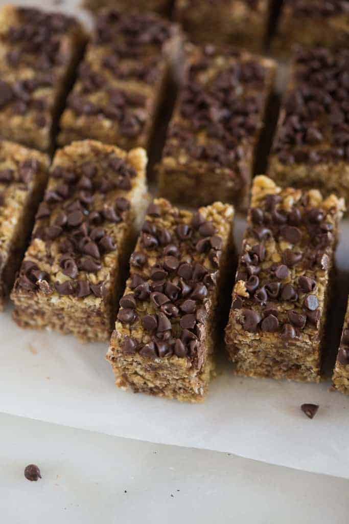 No bake granola bars placed in uneven lines on a white board.