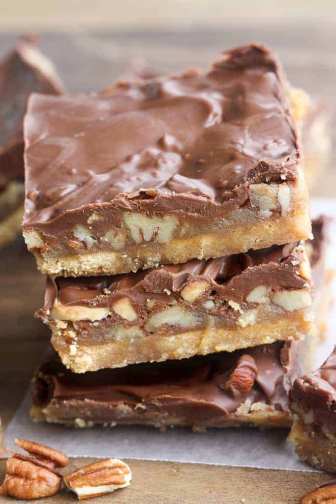 A stack of graham cracker toffee bars made with a graham cracker base, toffee center and chocolate on top.