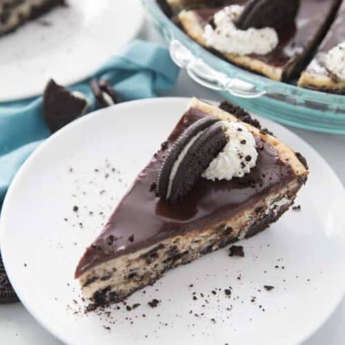 A slice of Oreo cheesecake on a white plate.