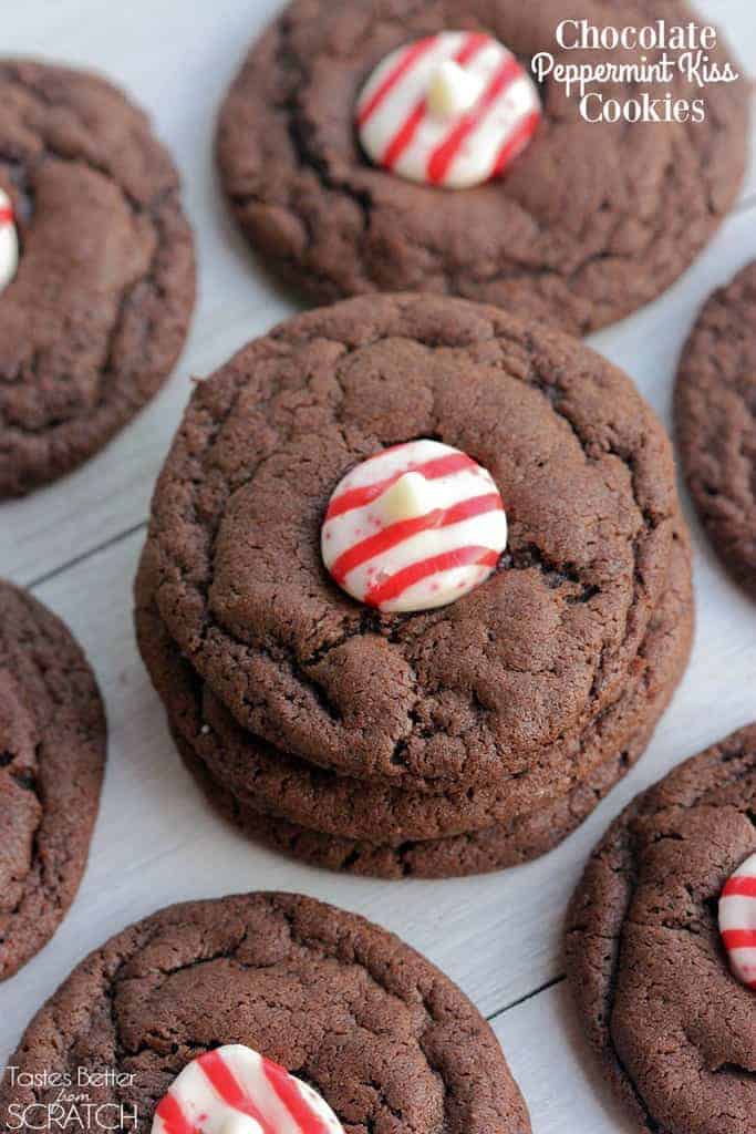 Several Chocolate Cookies with three cookies stacked on top of one another and a Hershey's peppermint kiss in the center of each cookie.