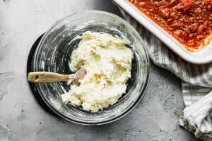 Ricotta and parmesan cheese mixed in a bowl.