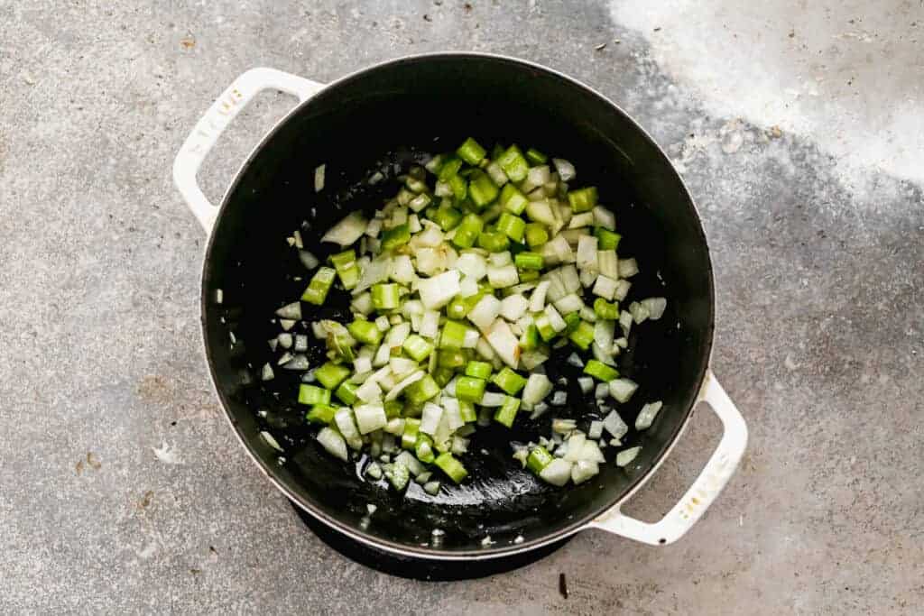 Chopped celery, onion and garlic sautéing in a skillet.