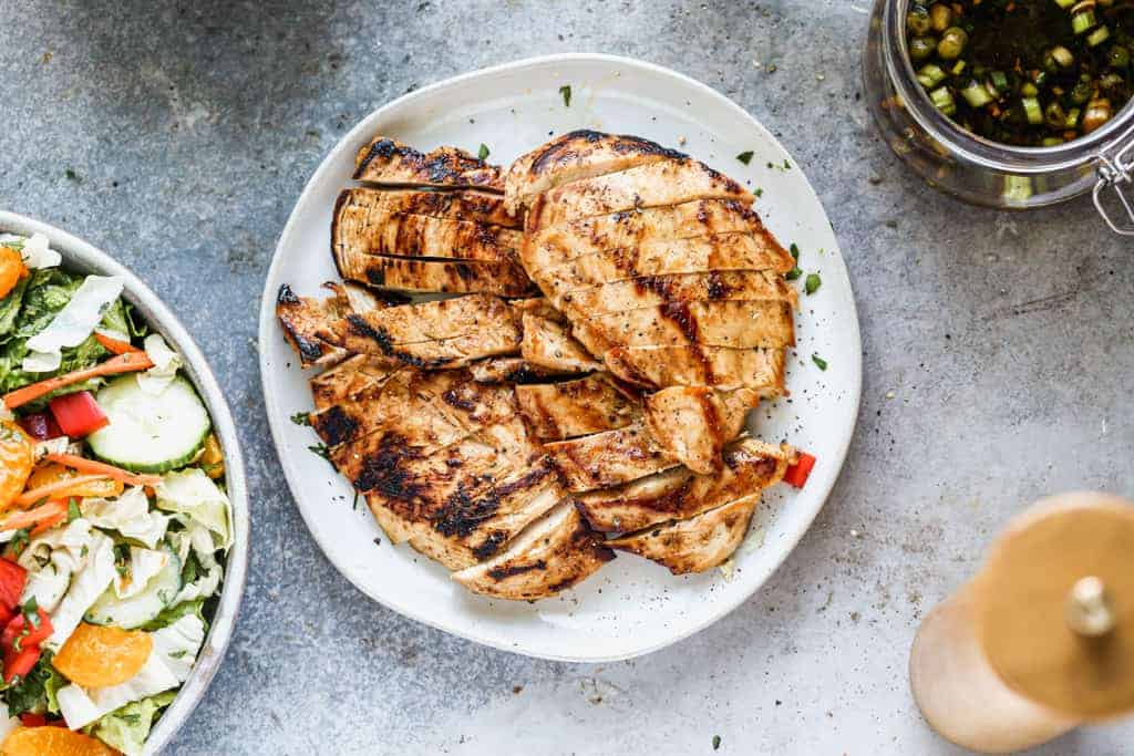 Marinated and grilled chicken, cut into slices for a salad.
