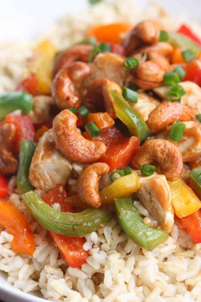 Skinny Asian Chicken Stir-Fry with Honey Roasted Cashews - an easy, healthy, flavorful meal packed with protein and veggies and served over brown rice. | Tastes Better From Scratch