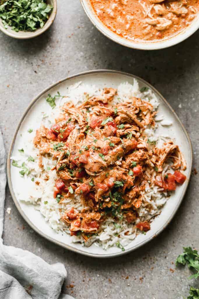 Slow Cooker Chicken Tikka Masala served over rice, on a plate.