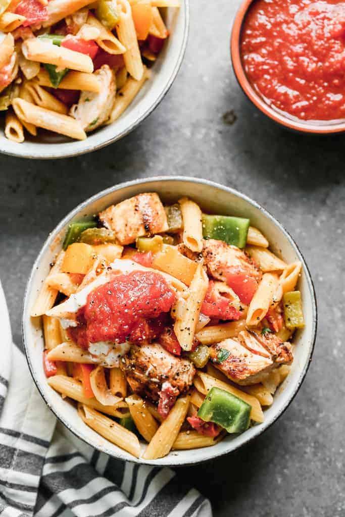 A bowl with a serving of chicken fajita pasta in it.