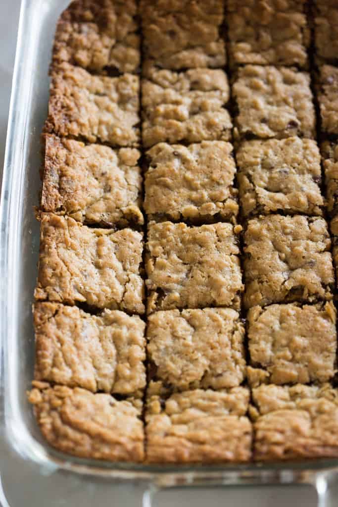 A pan of oatmeal chocolate chip cookie bars cut into squares, ready for serving.