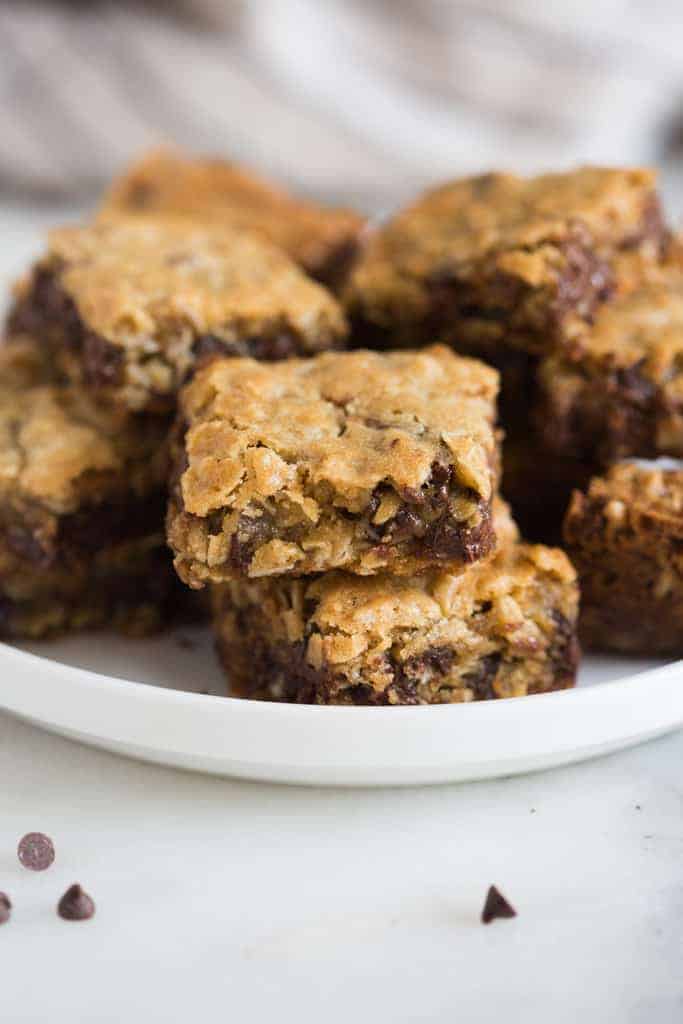Oatmeal Chocolate chip cookies bars stacked on a plate, ready to eat.