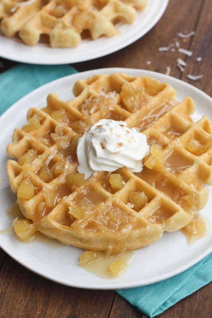 One Coconut Cream Waffle with Pineapple Syrup and whipped cream.