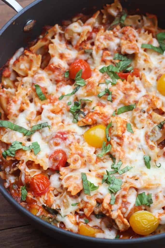 Chicken Mozzarella Pasta with Roasted Tomatoes in a skillet.