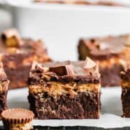 A Peanut Butter Brownie on a wire cooling rack with more brownies in the background.