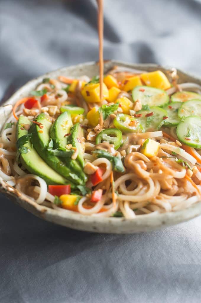 Spring roll bowls with rice noodles and vegetables and a thai sauce.