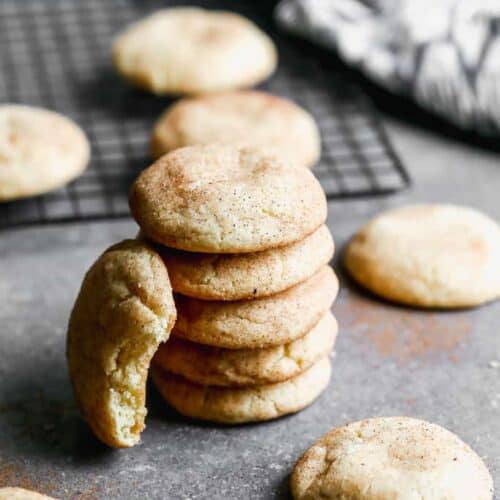 A stack of 5 snickerdoodles and another propped on the side.