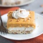 Pumpkin Dream Desert is a layered pudding dessert with a soft shortbread crust, whipped sweet cream cheese layer and pumpkin pudding layer. We love this easy fall dessert! | Tastes Better From Scratch