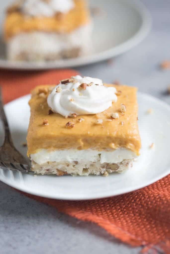 Pumpkin Dream Desert is a layered pudding dessert with a soft shortbread crust, whipped sweet cream cheese layer and pumpkin pudding layer. We love this easy fall dessert! | Tastes Better From Scratch