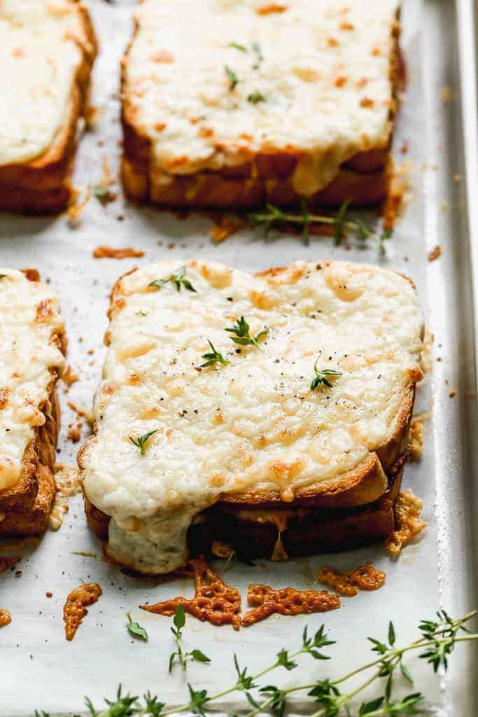 A baking tray with toasted croque monsieur sandwiches, hot from the oven.