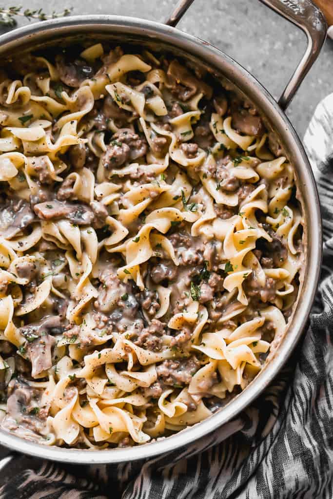 A skillet with stroganoff and egg noodles, cooked and ready to eat.