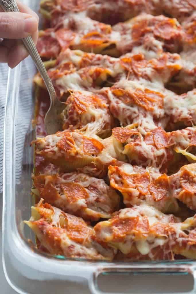 Pizza Stuffed Shells with tender noddles stuffed with a "pizza supreme" mixture and layered with sauce, pepperoni and cheese. | Tastes Better From Scratch