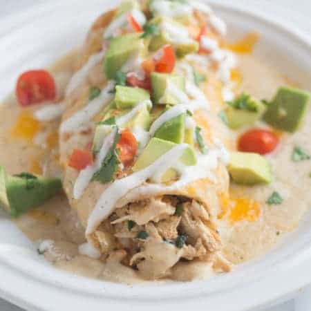 Smothered Ranch Chicken Burritos - delicious burritos, baked until crisp and then smothered in a creamy homemade ranch sauce. | Tastes Better From Scratch