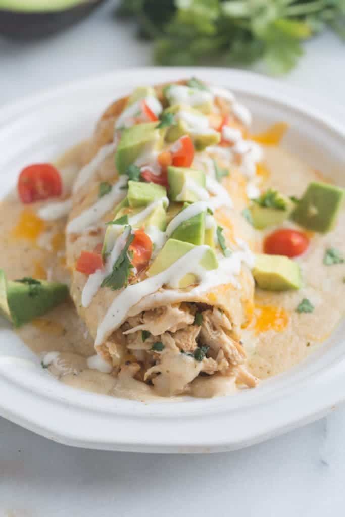 Smothered Ranch Chicken Burritos - delicious burritos, baked until crisp and then smothered in a creamy homemade ranch sauce. | Tastes Better From Scratch