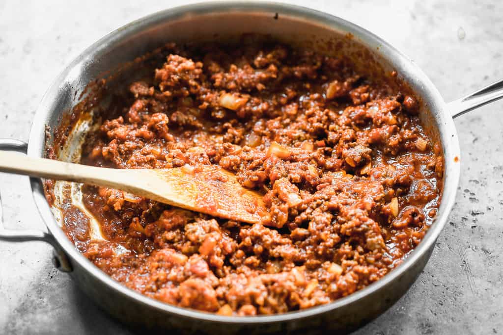 A skillet with homemade red spaghetti meat sauce.