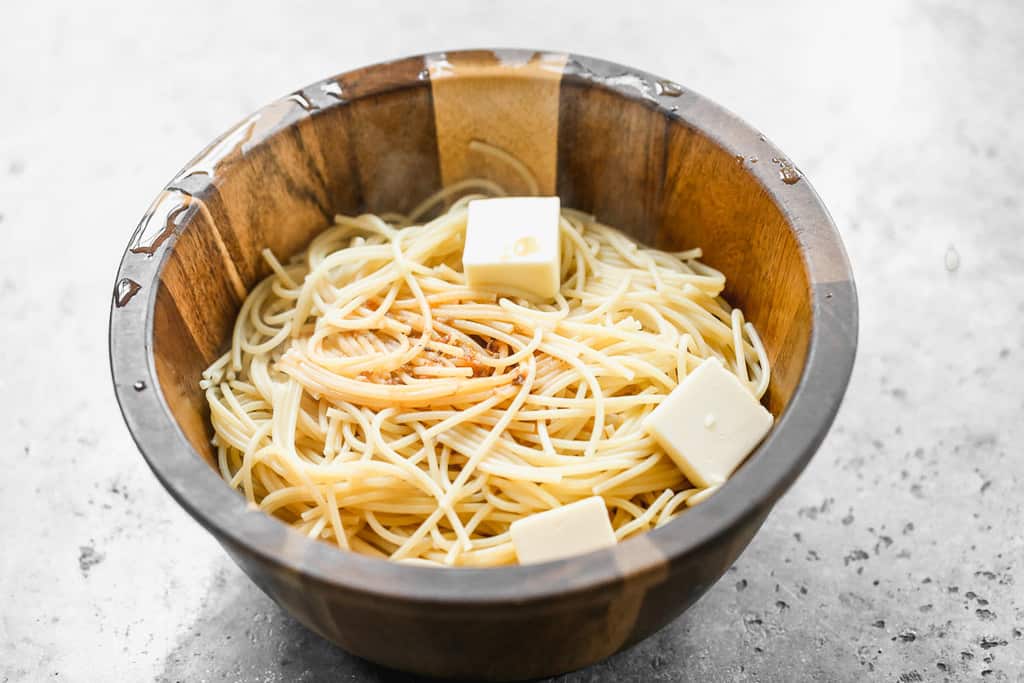 Hot noodles in a bowl with butter on top.
