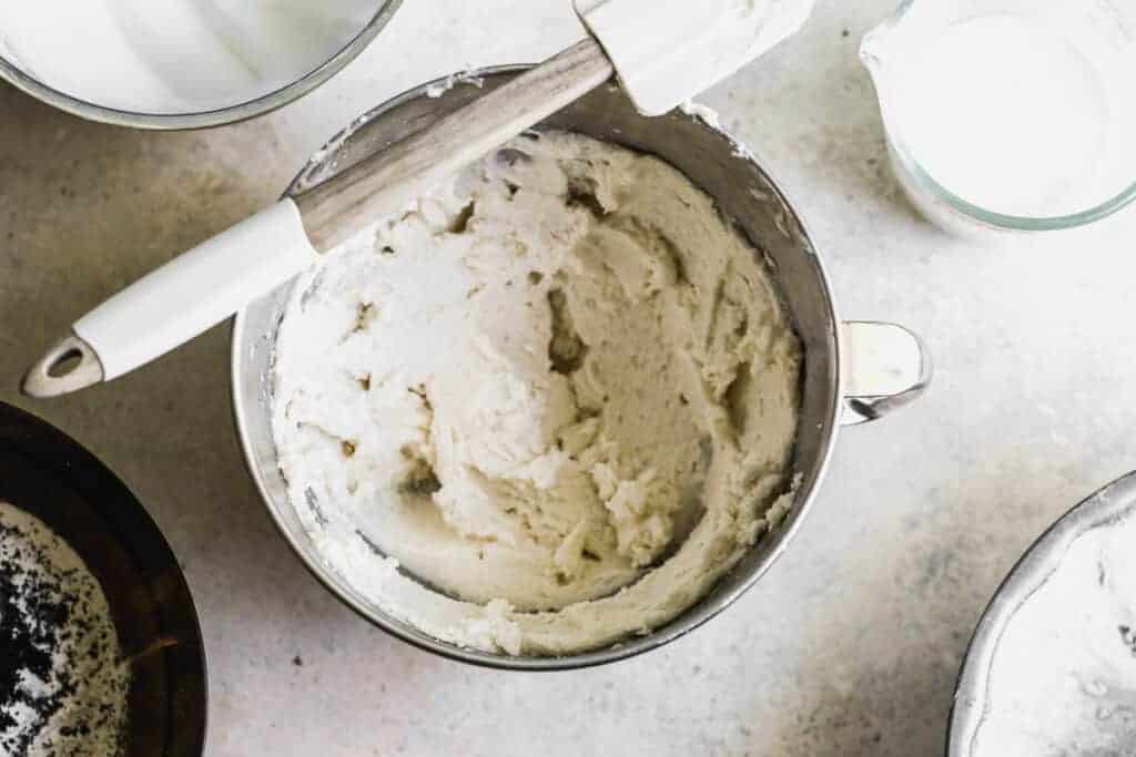 Butter, sugar, vanilla and milk combined in a mixing bowl.