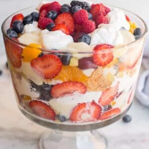 A trifle dish layered with fruit, pudding and cake.