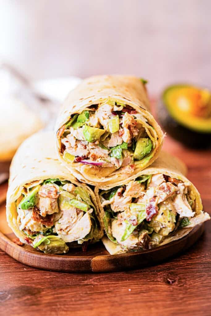 This healthy Chicken Avocado Wrap recipe is loaded with chicken, avocado, bacon, lettuce, and a creamy lemon sauce. It's ready in just 15 minutes and absolutely delicious!