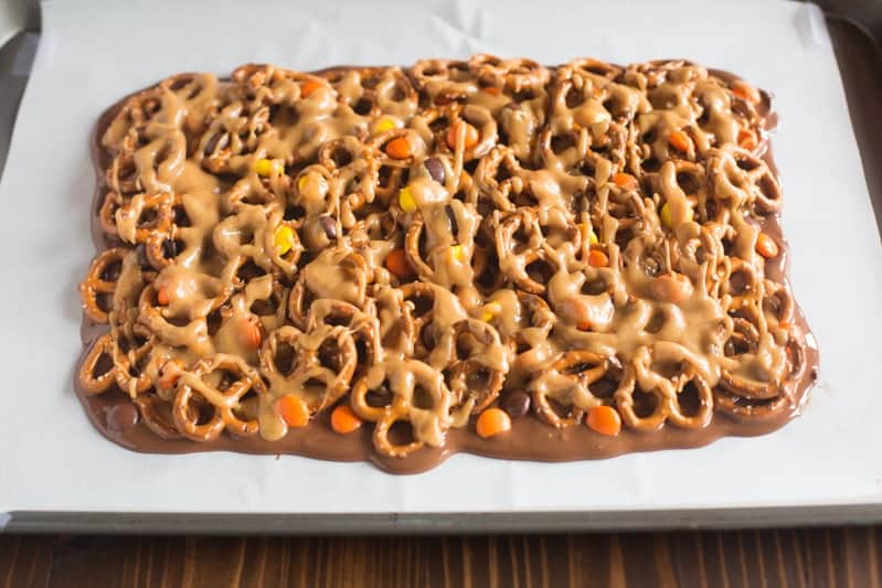 Chocolate and Peanut Butter Pretzel Bars on top of parchment paper.