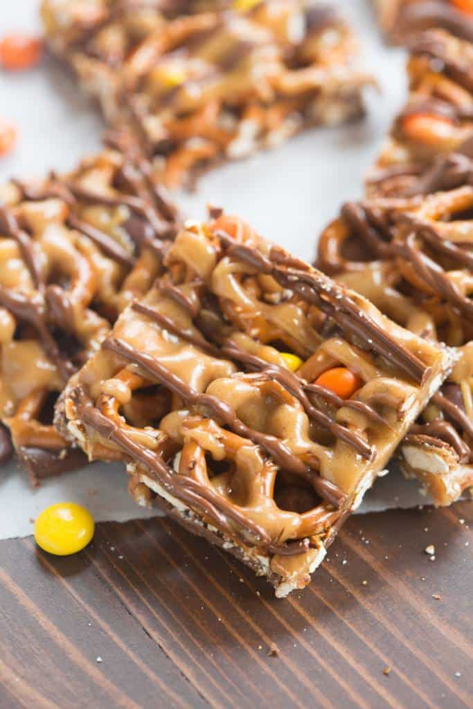 Peanut Butter and chocolate pretzel bars with Reese's pieces candy are one of our favorite simple, sweet and salty treats! | tastesbetterfromscratch.com