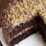 Homemade German Chocolate Cake is one of my favorite cakes of all time! Coconut pecan frosting, and chocolate frosting smoothed over a yummy and easy homemade chocolate cake. | tastesbetterfromscratch.com