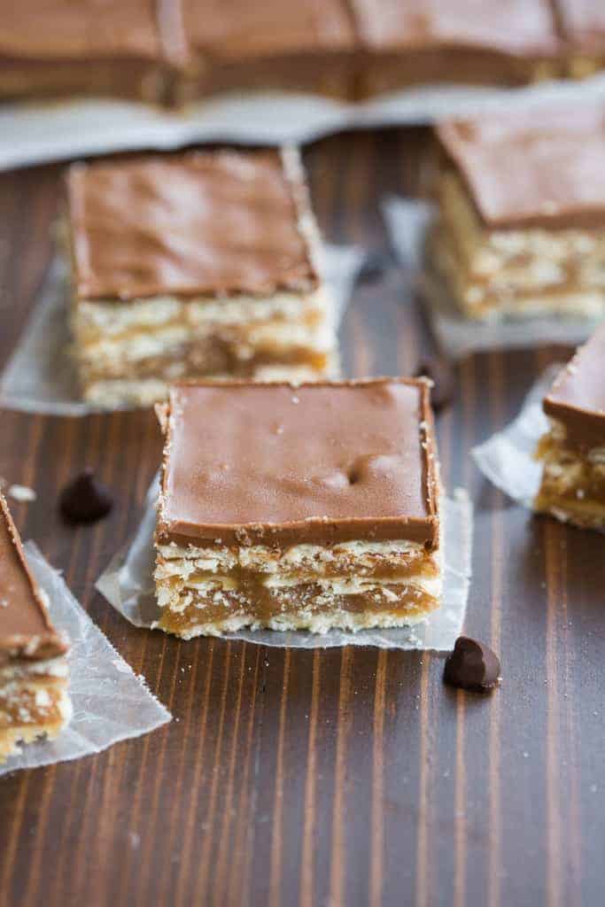 A close up of a caramel crunch bar with layers of club crackers, caramel, and chocolate.