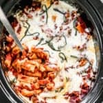 Crock Pot Baked Ziti in a slow cooker with a spoon in it for serving.