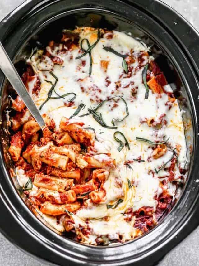 Crock Pot Baked Ziti in a slow cooker with a spoon in it for serving.