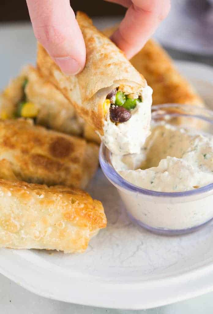 Southwest egg roll dipped in creamy cilantro sauce