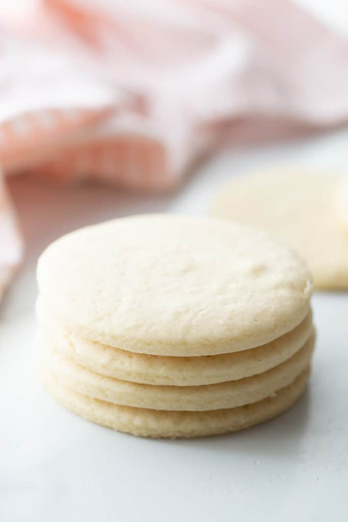A stack of baked, round, unfrosted sugar cookies.
